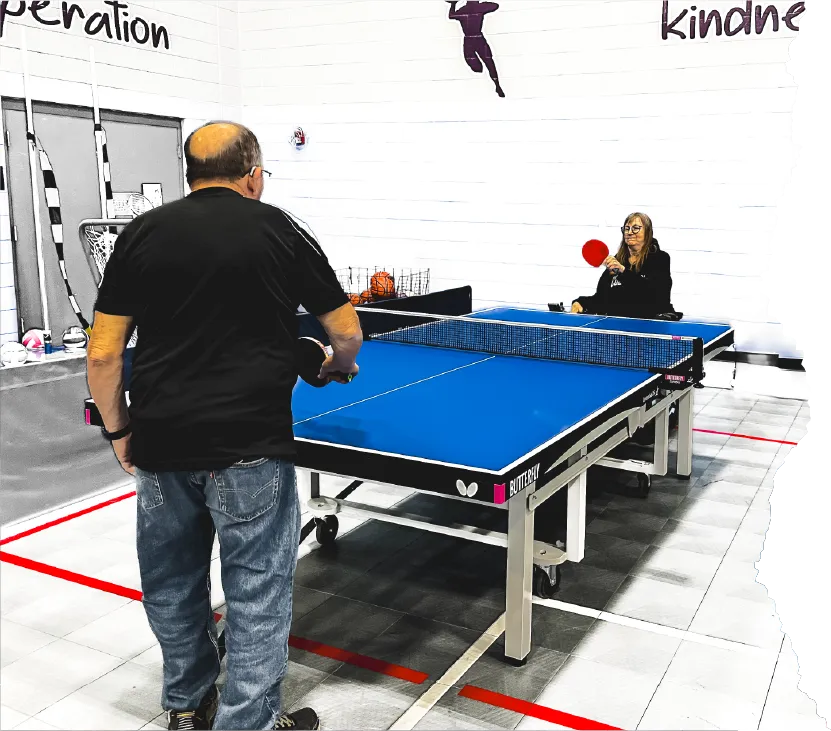 Two elderly people playing pingpong