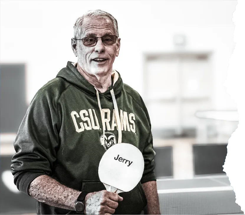 Elderly man holding pingpong bad