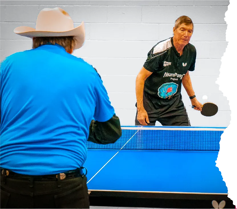 Two elderly people playing pingpong
